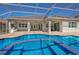 Inviting outdoor pool and spa area, perfect for relaxing and entertaining with an outdoor kitchen at 569 Mast Dr, Bradenton, FL 34208