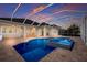 Screened in pool and spa, with brick pavers and backyard at 569 Mast Dr, Bradenton, FL 34208
