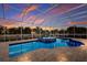 Screened pool and spa with brick pavers and sunset at 569 Mast Dr, Bradenton, FL 34208