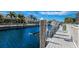 Scenic waterfront view with boat dock and lift, surrounded by lush landscaping and beautiful homes at 569 Mast Dr, Bradenton, FL 34208