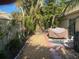 Private backyard with tropical landscaping, a stone path, and patio furniture at 5712 34Th W Ct, Bradenton, FL 34210