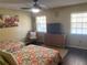 Cozy bedroom with two twin beds, ceiling fan, and dresser, creating a comfortable retreat at 5712 34Th W Ct, Bradenton, FL 34210