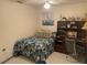 Inviting bedroom with a floral-patterned bedspread, a ceiling fan, and a built-in desk at 5712 34Th W Ct, Bradenton, FL 34210