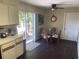 Eat-in kitchen featuring wood laminate flooring, a breakfast table, and sliding glass doors to the patio at 5712 34Th W Ct, Bradenton, FL 34210