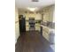 Efficient kitchen with white cabinets, stainless steel appliances, ample counter space, and wood-look flooring at 5712 34Th W Ct, Bradenton, FL 34210