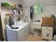 Functional laundry room with washer, dryer, sink, and storage for household chores at 5712 34Th W Ct, Bradenton, FL 34210