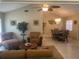 Open-concept living room flows into the dining area, featuring tiled flooring, ceiling fan, and natural light at 5712 34Th W Ct, Bradenton, FL 34210