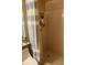 Shower stall featuring blue and white curtain and built-in shelving for toiletries at 5712 34Th W Ct, Bradenton, FL 34210