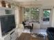 Cozy sunroom featuring tile flooring, comfortable seating, large windows, and a view of the backyard at 5712 34Th W Ct, Bradenton, FL 34210