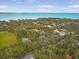 Panoramic aerial view showcasing a beautiful waterfront community with lush greenery and clear blue water at 5716 Bayshore Blvd, Tampa, FL 33611