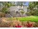 Expansive backyard with a manicured lawn, a cozy patio, and mature trees, offering a private outdoor oasis at 5716 Bayshore Blvd, Tampa, FL 33611