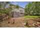 Spacious backyard featuring a well-maintained lawn, mature trees, and a charming patio with outdoor seating at 5716 Bayshore Blvd, Tampa, FL 33611