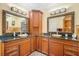 Luxurious bathroom with dual sinks, granite countertop, and ornate mirror frames at 5716 Bayshore Blvd, Tampa, FL 33611