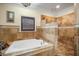 Elegant bathroom featuring a soaking tub, tiled walls, and walk-in shower at 5716 Bayshore Blvd, Tampa, FL 33611