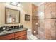 Bathroom features granite countertops, framed mirror, and a tile-walled walk-in shower at 5716 Bayshore Blvd, Tampa, FL 33611