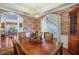 Charming dining room with exposed brick wall, elegant chandelier, and beautiful hardwood floors at 5716 Bayshore Blvd, Tampa, FL 33611