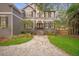Charming two-story home with a neatly landscaped front yard and a brick-paved walkway at 5716 Bayshore Blvd, Tampa, FL 33611