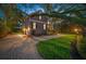 Stately home featuring a brick driveway, manicured lawn, and beautiful mature trees at 5716 Bayshore Blvd, Tampa, FL 33611
