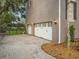 Spacious three-car garage with updated doors, exterior lighting, and brick paved driveway at 5716 Bayshore Blvd, Tampa, FL 33611