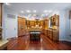 Spacious kitchen features wood cabinetry, hardwood flooring, and a center island with seating at 5716 Bayshore Blvd, Tampa, FL 33611
