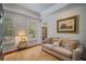 Bright living room with hardwood floors, decorative windows, and cozy seating area at 5716 Bayshore Blvd, Tampa, FL 33611