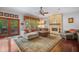 Comfortable living room boasts a stone fireplace, hardwood floors, and ample natural light at 5716 Bayshore Blvd, Tampa, FL 33611
