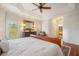 Bright main bedroom features a tray ceiling, white brick walls, and elegant décor at 5716 Bayshore Blvd, Tampa, FL 33611