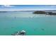 Scenic aerial view of kayakers, boats, and the coastline, with clear turquoise water and lush greenery at 7030 Lois Ave, Longboat Key, FL 34228