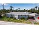 Charming exterior with stone pathway and lush tropical landscaping at 7030 Lois Ave, Longboat Key, FL 34228