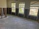 Living room featuring three windows with studs exposed at 7030 Lois Ave, Longboat Key, FL 34228