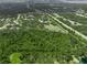 An aerial view showcases an expansive property featuring a modern home surrounded by lush greenery and an outlined boundary at 7234 Letitia Ln, Sarasota, FL 34241