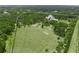 Aerial view of a large property featuring a home surrounded by lush greenery at 7234 Letitia Ln, Sarasota, FL 34241