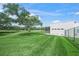 Spacious backyard with well-maintained lawn and modern home architecture at 7234 Letitia Ln, Sarasota, FL 34241