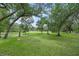 Expansive backyard featuring lush greenery and mature trees at 7234 Letitia Ln, Sarasota, FL 34241