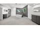 Modern bathroom featuring a soaking tub, tiled shower, vanity, and natural light from a large window at 7234 Letitia Ln, Sarasota, FL 34241
