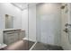 Modern bathroom featuring a glass-enclosed shower and stylish vanity with dark stone countertops at 7234 Letitia Ln, Sarasota, FL 34241