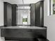 Bathroom featuring modern cabinets, granite counters, and sleek mirror at 7234 Letitia Ln, Sarasota, FL 34241