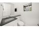 Modern half bathroom with a vessel sink, sleek countertop, and stylish square mirror at 7234 Letitia Ln, Sarasota, FL 34241