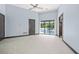 Spacious bedroom with light blue walls, tiled floor, ceiling fan, and pool view at 7234 Letitia Ln, Sarasota, FL 34241