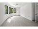 Sun-filled room featuring ceramic tile floors and curved windows framing the lush greenery at 7234 Letitia Ln, Sarasota, FL 34241