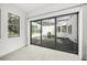 Indoor view of a tranquil courtyard with a pond, stone features, rock ground cover, and screened ceiling at 7234 Letitia Ln, Sarasota, FL 34241