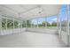 Enclosed porch with ceiling fans and a view of the surrounding greenery at 7234 Letitia Ln, Sarasota, FL 34241