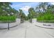 View of the ornate white entrance gate for this estate, offering both privacy and a welcoming presence at 7234 Letitia Ln, Sarasota, FL 34241