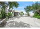 Grand entrance of a contemporary home with manicured landscaping at 7234 Letitia Ln, Sarasota, FL 34241