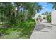 Modern home's exterior featuring a landscaped yard and winding driveway at 7234 Letitia Ln, Sarasota, FL 34241
