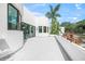 Exterior view showcasing a modern home with a patio and tropical landscaping at 7234 Letitia Ln, Sarasota, FL 34241
