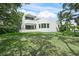 Modern home with curved architecture, balconies, and lush green lawn at 7234 Letitia Ln, Sarasota, FL 34241