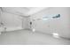 Clean and spacious garage featuring epoxy flooring, ample lighting, and convenient access points at 7234 Letitia Ln, Sarasota, FL 34241