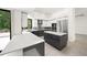 Modern kitchen with stainless steel appliances, gray cabinetry, and a center island at 7234 Letitia Ln, Sarasota, FL 34241