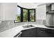 Corner kitchen sink with stainless steel faucet and modern white cabinets, with a view of the outdoors at 7234 Letitia Ln, Sarasota, FL 34241